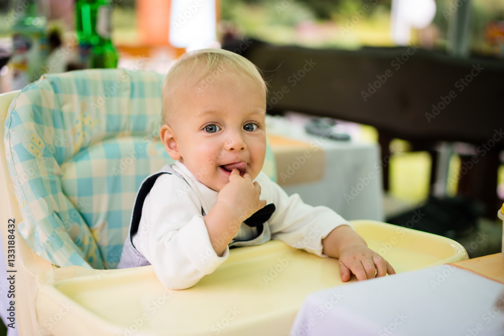 Baby boy sitting in a modern pram Baby boy sitting in a modern pram