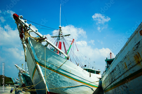 Wooden sailing ships called pinisi in the historical port of Sunda Kelapa in Jakarta, Central Java, Indonesia. photo
