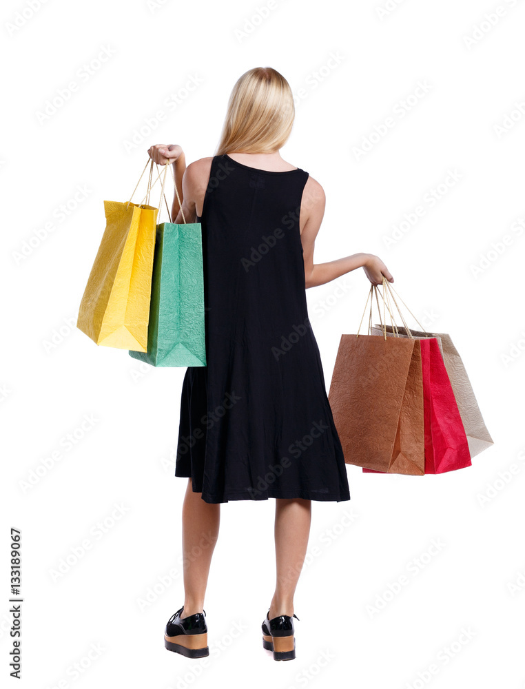 back view of woman with shopping bags . beautiful brunette girl in motion.  backside view of person.  Rear view people collection. Isolated over white background. 