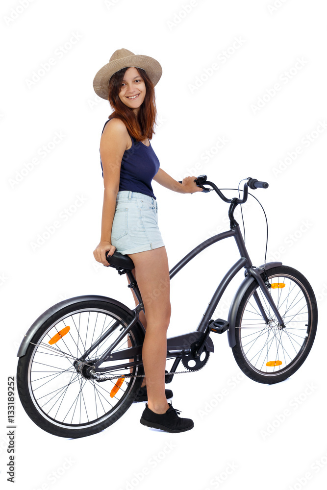back side view of a woman with a bicycle. cyclist sits on the bike