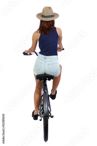 back view of a woman with a bicycle. cyclist sits on the bike. Rear view people collection.  backside view of person. Isolated over white background. Girl in a straw hat riding a bicycle.