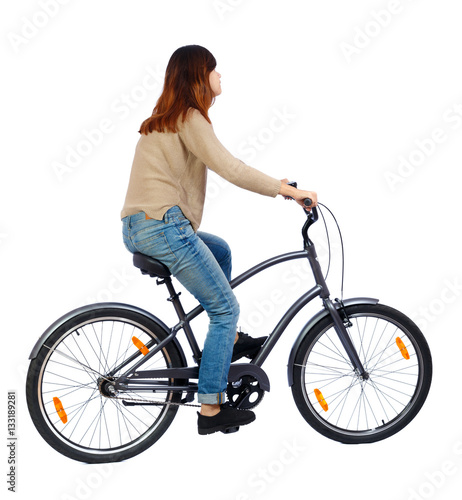 side view of a woman with a bicycle. cyclist sits on the bike. Rear view people collection. backside view of person. Isolated over white background. The girl in the brown jacket rides a stylish bike.