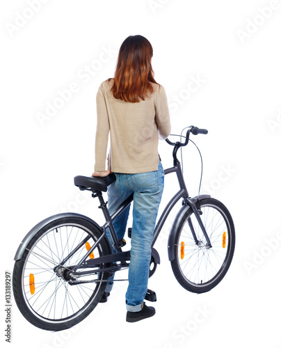 back side view of a woman with a bicycle. cyclist sits on the bike. Rear view people collection.  backside view of person. Isolated over white background. Girl on bike is looking to the side.