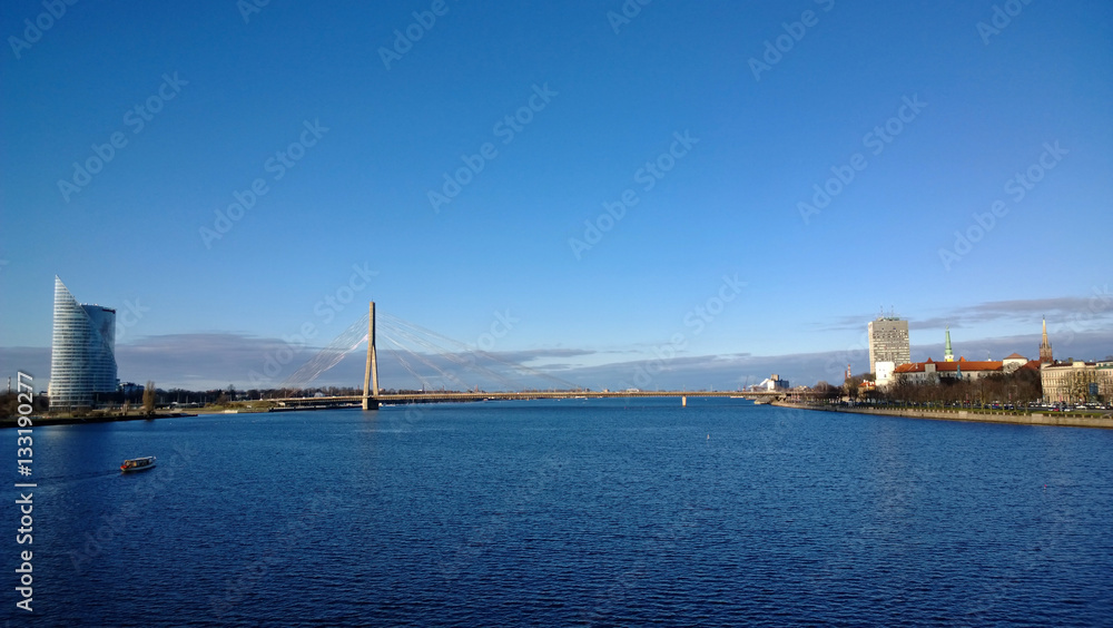 River Daugava in Riga with the view of the bridge on a Sunny day