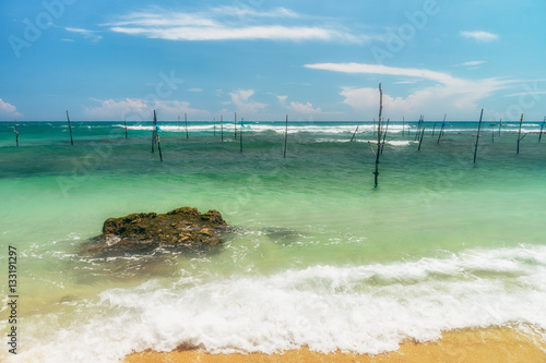 Sunny beach near Koggala - Sri Lanka. Waves of clear water and warm sand  photo