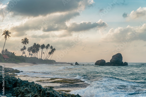 Sunny beach near Koggala - Sri Lanka. Waves of clear water and warm sand  photo