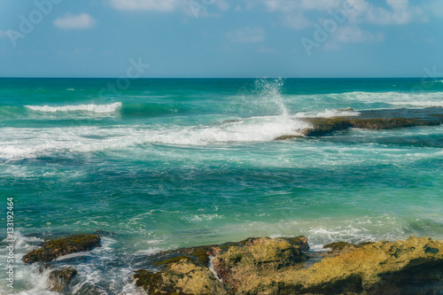 Sunny beach near Koggala - Sri Lanka. Waves of clear water and warm sand  photo