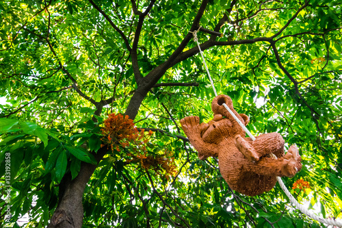 stucco/brick monkey is hanging with the big tree, wonderful wild