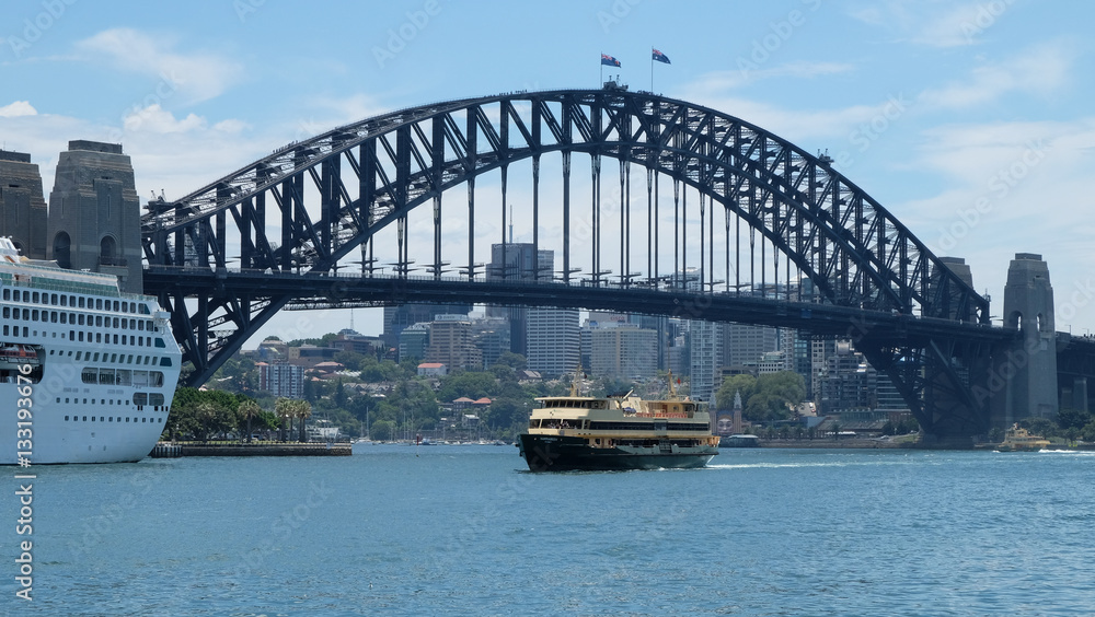 Sydney Ferry on harbour passing in front of bridge Sydney Ferry on harbour passing in front of bridge