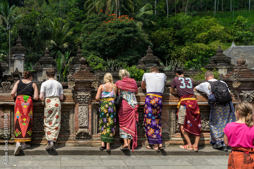 Temple Tourists. Tourists wearing traditional Balinese sarong at Tirta Empul temple, Ubud, Bali.