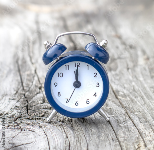 Retro Alarm on Wooden Background.