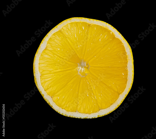 A slice of lemon on black background.
