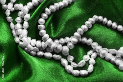 Pearl on green satin