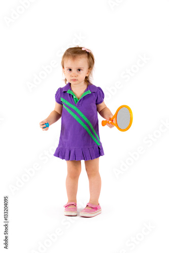 Little cute girl playing tennis on a white background