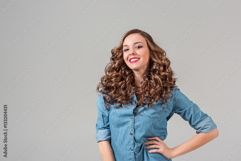 The smiling girl on gray studio background The smiling girl on gray studio background