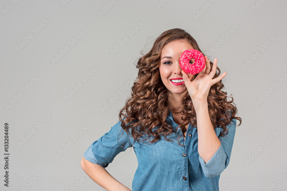 The smiling girl on gray studio background with round cake The smiling girl on gray studio background with round cake