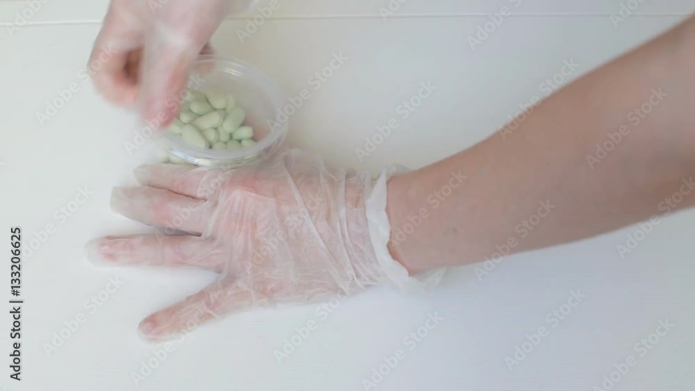 Doctor take pills from container Doctor take pills from container