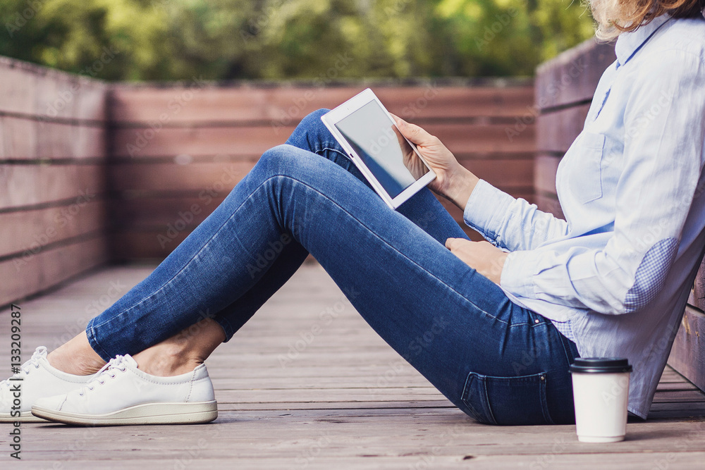 Young girl using digital tablet outdoors Young girl using digital tablet outdoors