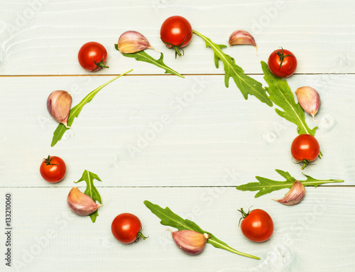 arugula leaves, garlic and tomatoes