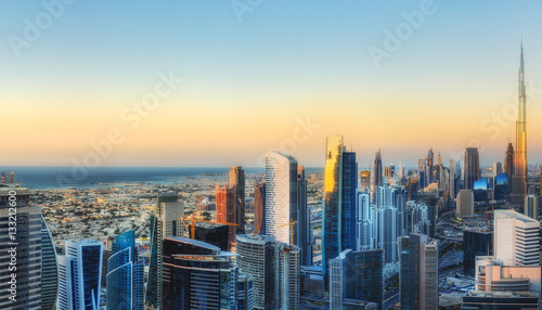 Fantastic aerial view over a big modern city with skyscrapers. Downtown Dubai, United Arab Emirates. Colorful futuristic cityscape.
