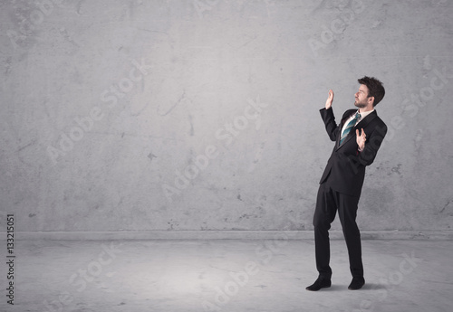 Young businessman standing confused
