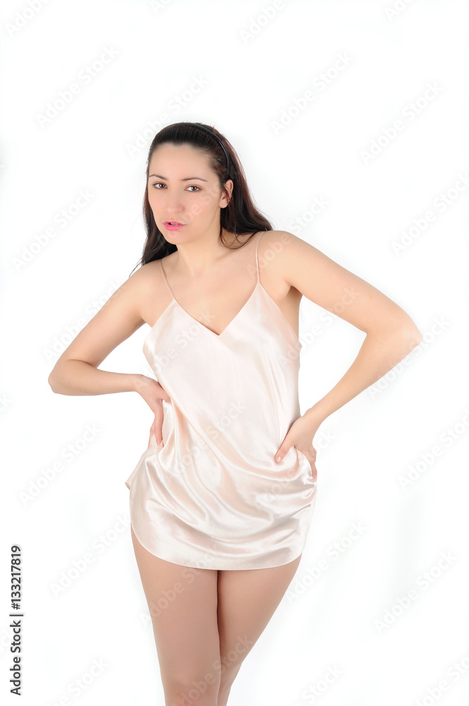 Young long-haired brunette in a silk shirt on a white background Young long-haired brunette in a silk shirt on a white background