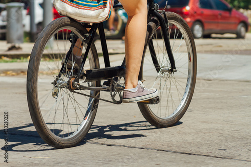 Woman legs riding a bicycle down the street © simonmayer