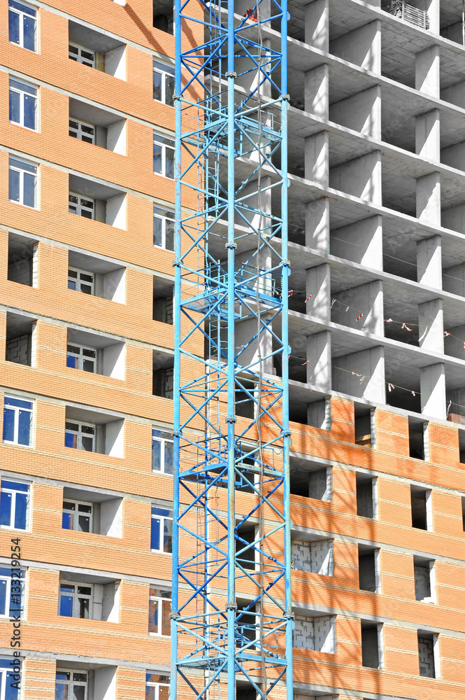Crane and highrise construction site Crane and highrise construction site