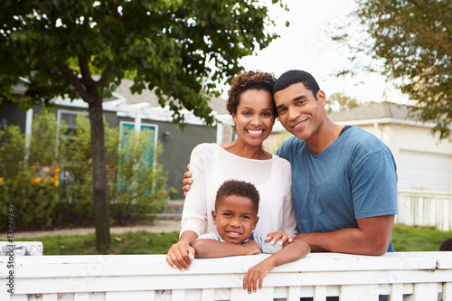 Young African American family outside their new house