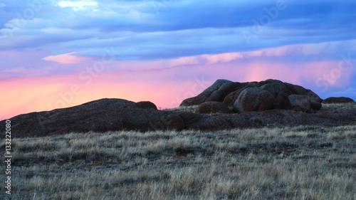 Sunset lit clouds over a rock formation near Laramie Wyoming. photo