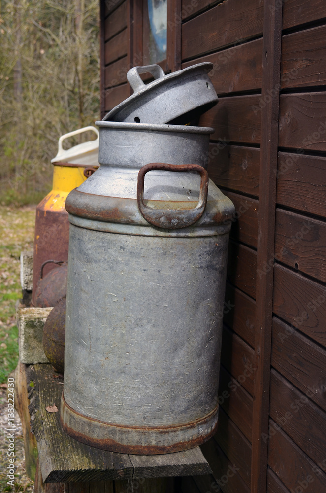 Vintage milk can at garden shed