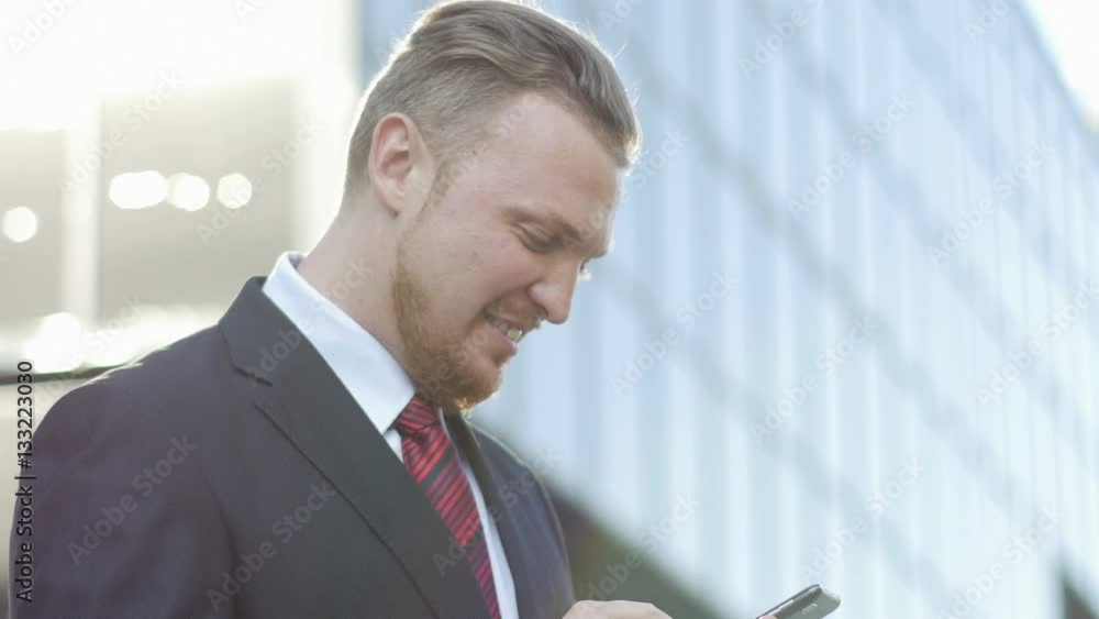 successful businessman looking at the phone screen says successful businessman looking at the phone screen says