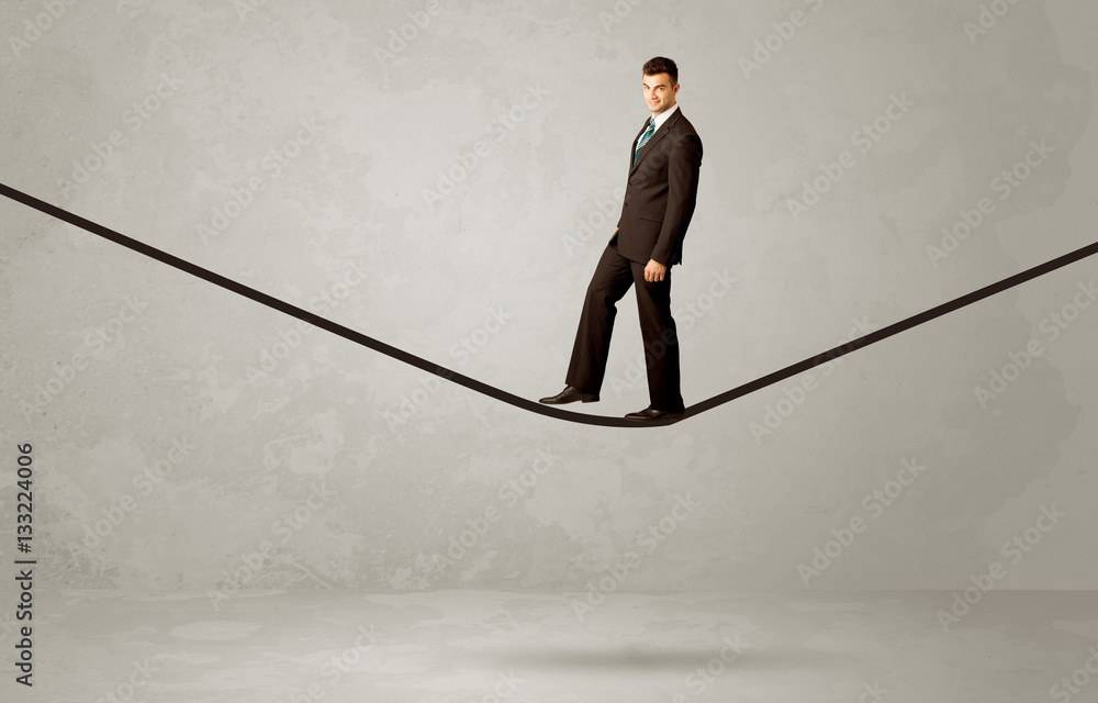 Salesman walking on rope in grey space Salesman walking on rope in grey space