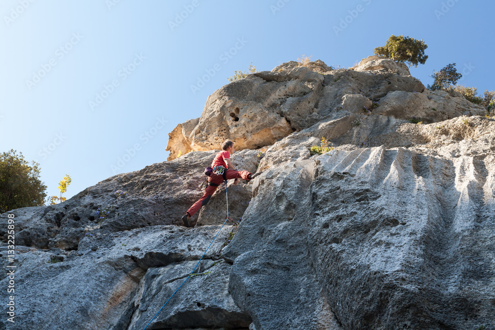 Man climbing on a limestone wall Man climbing on a limestone wall