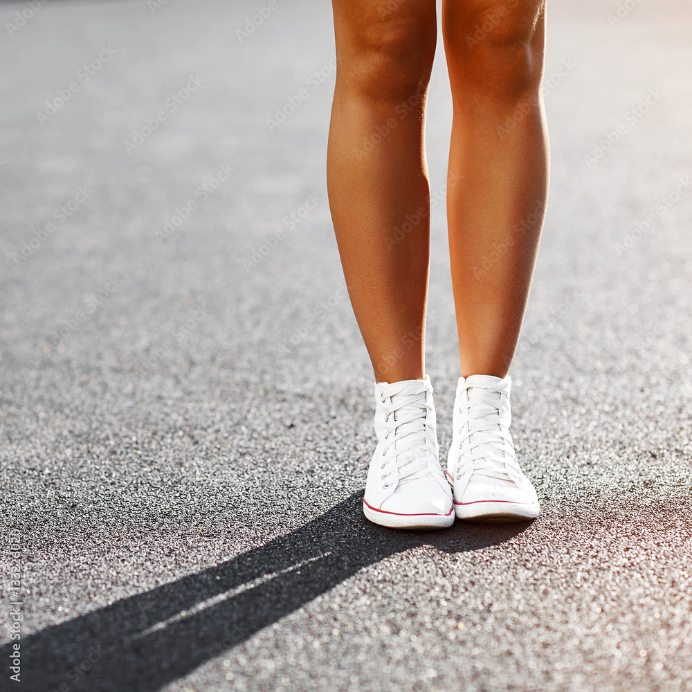 Girl's legs in sneakers - close up