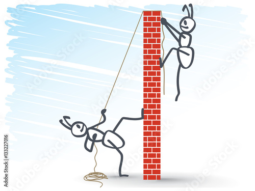 2 ants helping each other over a brick wall