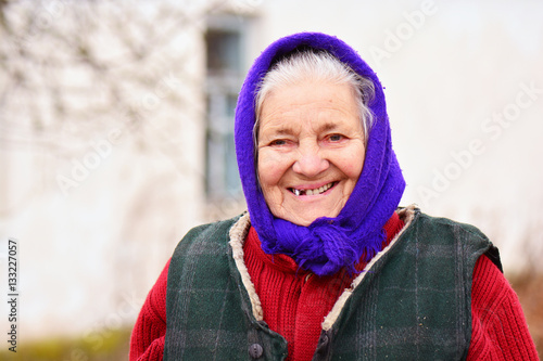 Portrait of old woman in blue headscarf