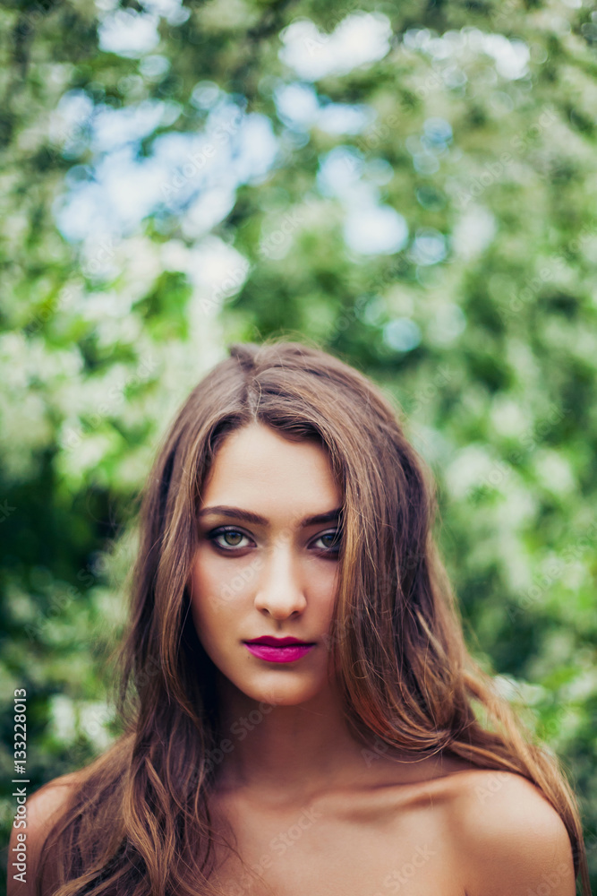 Portrait of young beautiful woman posing among spring blossom trees. Portrait of young beautiful woman posing among spring blossom trees.