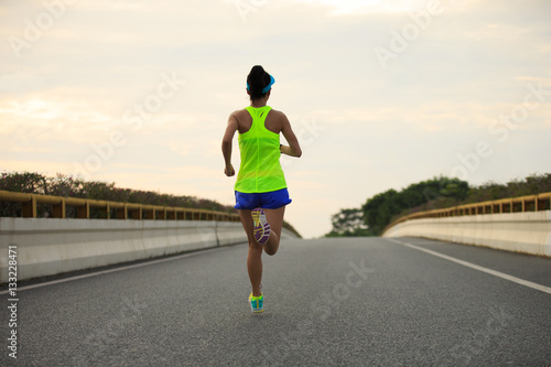 young fitness asian woman runner running on city road © lzf