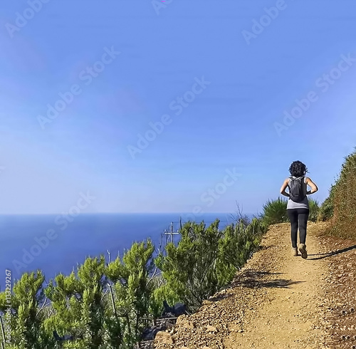 path girl between sea and mountains