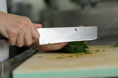 Chef training cut vegetable on cutting board with knife japan