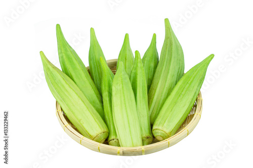 Fresh young okra in .Bamboo Basket isolated on white background