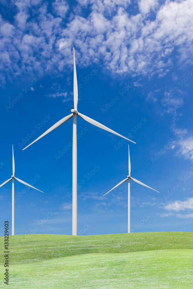 Wind turbines on grass field and blue sky Wind turbines on grass field and blue sky