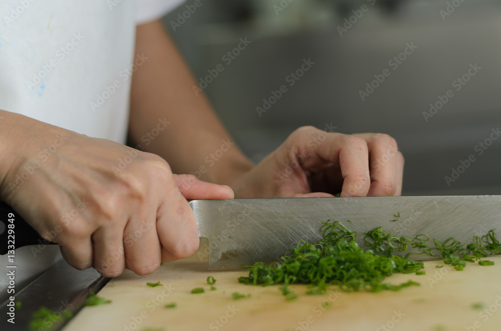 Chef training cut vegetable on cutting board with knife japan Chef training cut vegetable on cutting board with knife japan