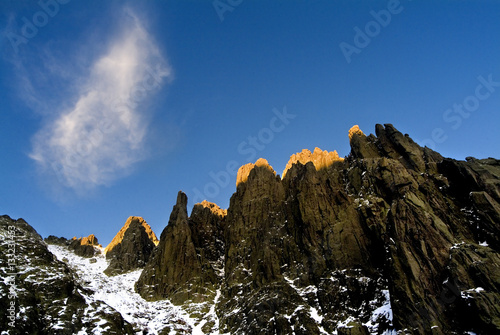 Top of the mountains lighten by the lat rays of a sunset photo