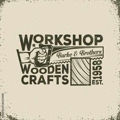 Workshop of the Joiner or Carpenter Vintage Logo - Hand Holding a Saw and Sawing of Wood. Vector illustration - worn texture and background on separate layers, can disable, easy to edit.
