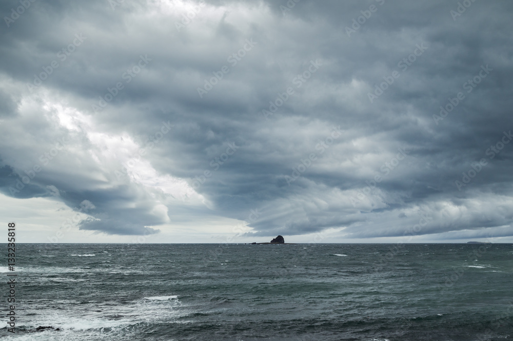 Dramatic and dark clouds above ocean on Jeju Island in South Korea. Dramatic and dark clouds above ocean on Jeju Island in South Korea.