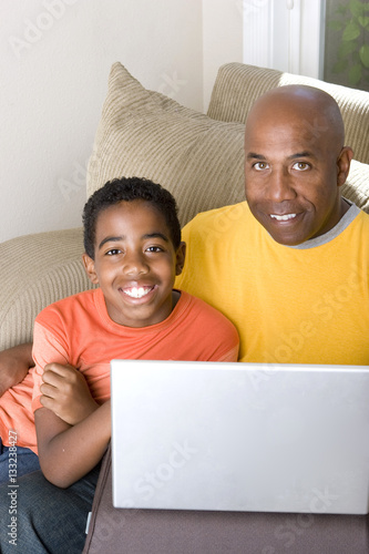 African American Father and son on the computer.