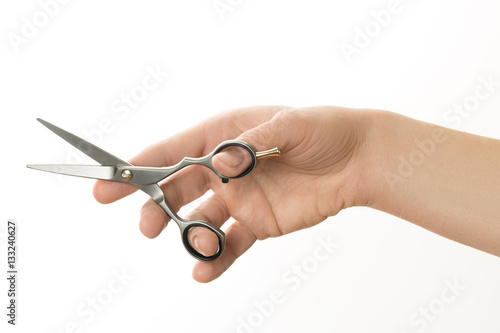 hairdresser holding in hand scissors for cutting hair isolated on white background