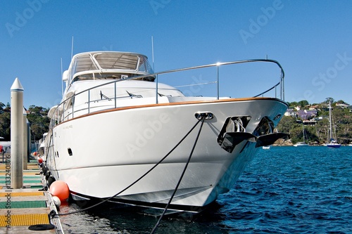 Luxury motor yacht bow view closeup moored at a marina dock. Sydney, Australia.